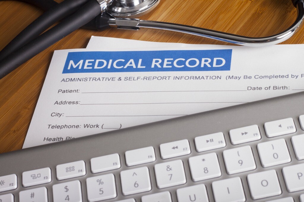 Stethoscope resting on a sheet of medical insurance records